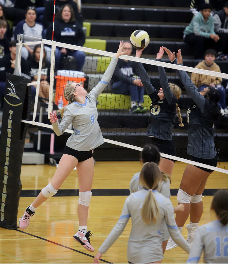 Mountain Range's Maddison Eliason goes up for a kill against Prairie View's Jenna Sheley (10) and Elena Gonzales (13).